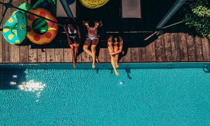 Chicas disfrutando del agua limpia de la piscina gracias a la depuradora